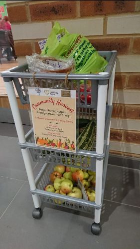 Trolley with apples and other fruit and veg in it